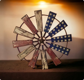 A wooden windmill with stars painted on it.