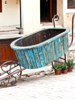 A wooden tub on wheels in the middle of a courtyard.