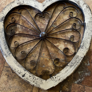 A heart shaped wooden box with metal work.