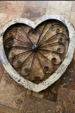 A heart shaped wooden box with metal work.