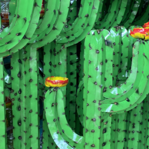 A bunch of green cactus with yellow flowers