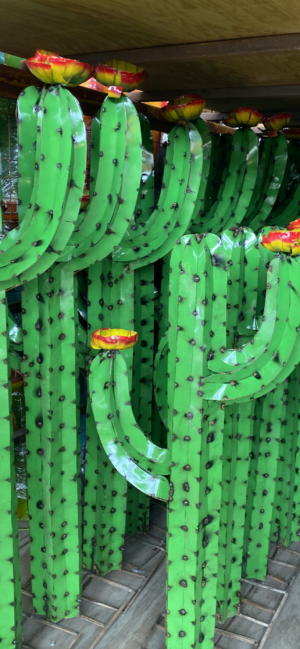 A bunch of green cactus with yellow flowers