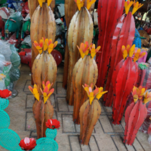 A group of wooden sculptures with yellow flowers.