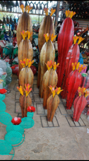 A group of wooden sculptures with yellow flowers.