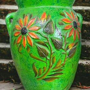 A green vase with flowers and leaves painted on it.