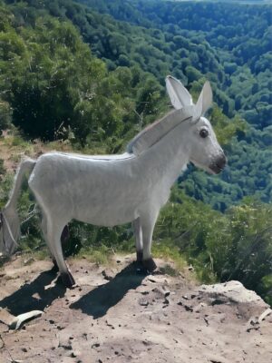 A goat standing on top of a mountain.